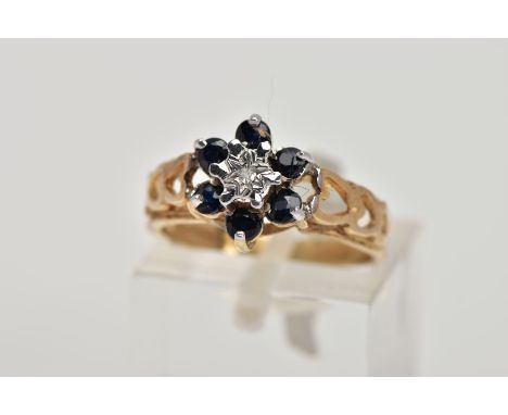 A 9CT GOLD SAPPHIRE AND DIAMOND CLUSTER RING, the raised cluster of a flower shape, set with a central illusion set, single c