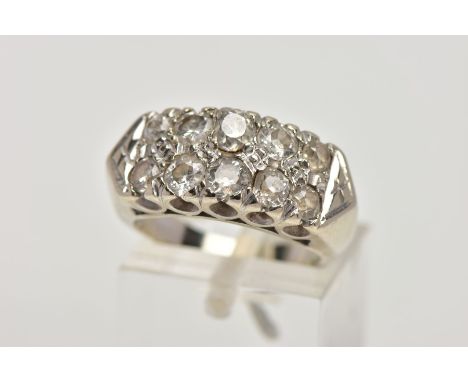 A WHITE METAL DIAMOND RING, designed with two rows of claw set, graduated old and round brilliant cut diamonds, total estimat