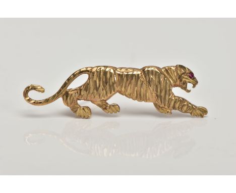 A 9CT GOLD BROOCH, in the form of a realistically stylised tiger, set with a circular cut ruby eye, fitted with a brooch pin,