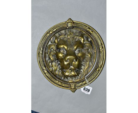 A CAST BRASS CIRCULAR DOOR KNOCKER, with Lion mask back plate and full circular frame knocker, diameter 23 cm, in working ord