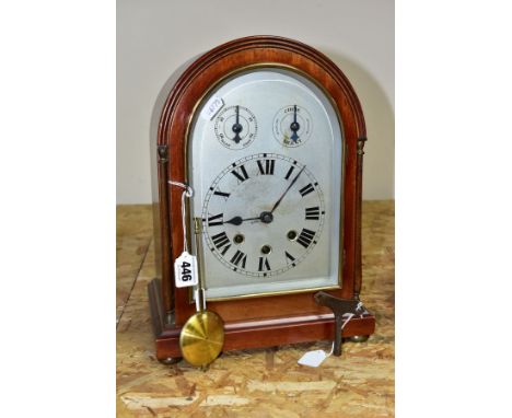 AN EARLY 20TH CENTURY MAHOGANY CASED DOME TOP MANTEL CLOCK, silver coloured arched dial with slow/fast and chime/silent dials