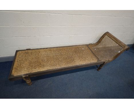 A 19TH CENTURY ANGLO-INDIAN CANED HARDWOOD DAYBED, with a scrolled and swept top rail, on bulbous and turned legs united by a