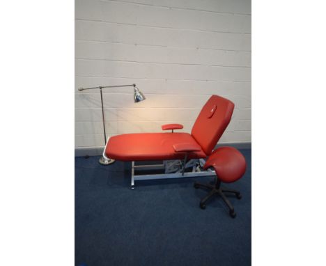 A RED LEATHER ELECTRIC SPORTS MASSAGE TABLE, that's suitable for Therapy, physio and osteopathy, along with matching saddle s