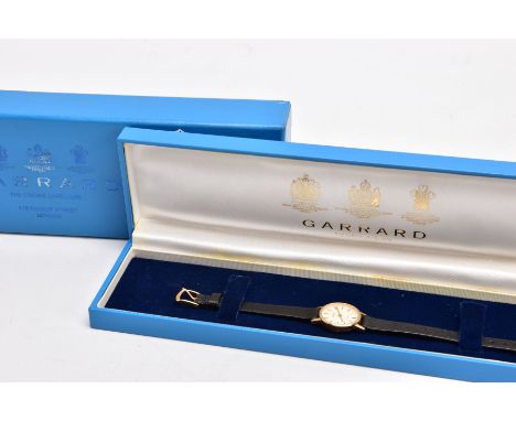 A LADIES 9CT GOLD 'GARRARD' WRISTWATCH, quartz movement, round champagne dial signed 'Garrard', baton markers, gold hands, pl