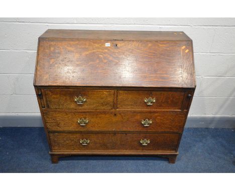 A GEORGIAN OAK BUREAU, with a fitted interior, above four drawers, on bracket feet, width 107cm x depth 48cm x height 104cm (