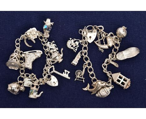 TWO SILVER CHARM BRACELETS, the first fitted with eleven charms in forms such as a key, teapot, crystal owl, bell, ice skate,