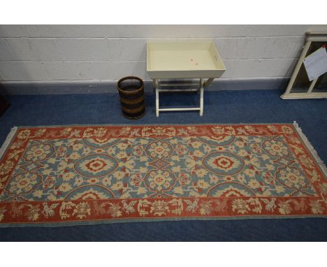 A WOOLLEN RED AND BLUE CARPET RUNNER, 280cm x 93cm, along with a cream folding butlers tray and an umbrella stand (3)