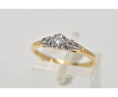 A FIVE STONE DIAMOND RING, designed with a central brilliant cut diamond within an eight claw mount, flanked by two single cu