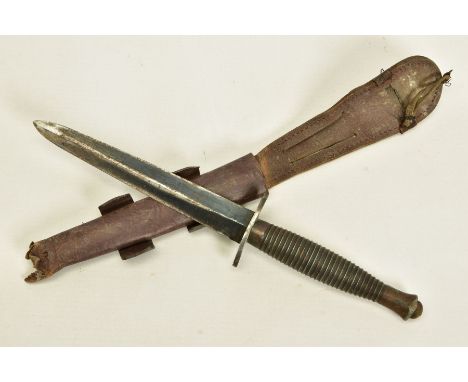 AN EXAMPLE OF A MKIII VARIANT OF THE FAIRBURN SYKES FIGHTING KNIFE, together with leather scabbard, the blade, cross guard an
