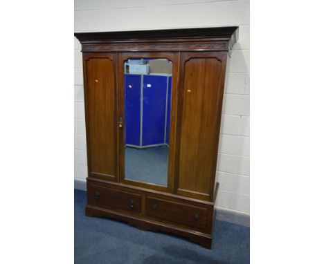 AN EDWARDIAN MAHOGANY MIRRORED SINGLE DOOR WARDROBE, the cornice with blind fretwork, above two drawers, width 158CM x depth 