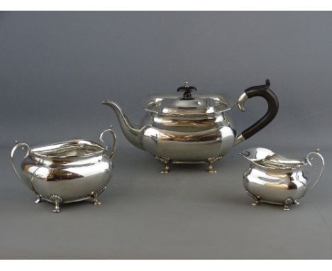 A THREE PIECE SILVER TEASET comprising teapot, sugar basin and milk jug, simple plain form with shaped top edges, 'C' shaped 