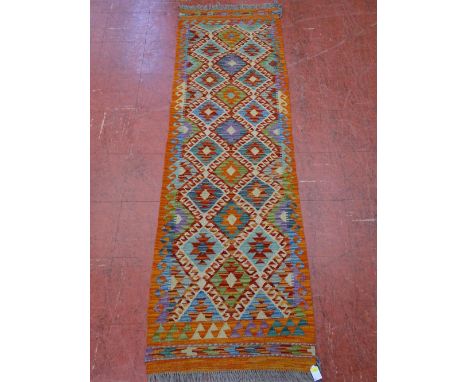 A VEGETABLE DYE WOOL CHOBI KELIM CARPET RUNNER, vibrant colours with wave border and multi-diamond central pattern, 193 x 64 