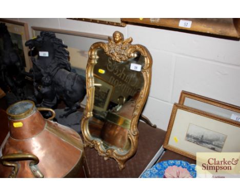 A gilt cherub decorated easel mirror 