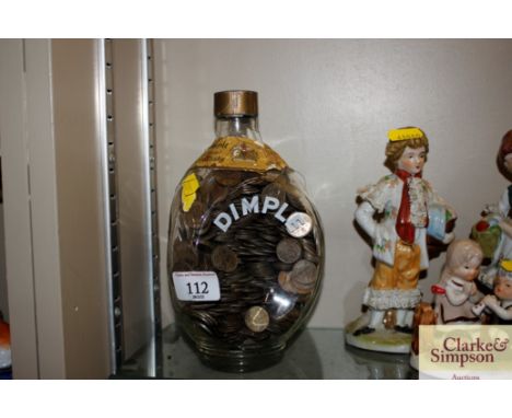 A Dimple Scotch Whisky bottle and contents of old sixpences 