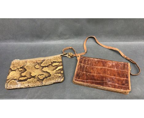 A vintage crocodile skin hand bag with strap and a snakeskin clutch bag with zip fastener