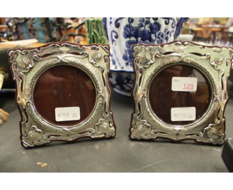 A pair of Edward VII silver photograph frames of Art Nouveau design, Birmingham 1905 by Henry Matthews, with later mahogany b