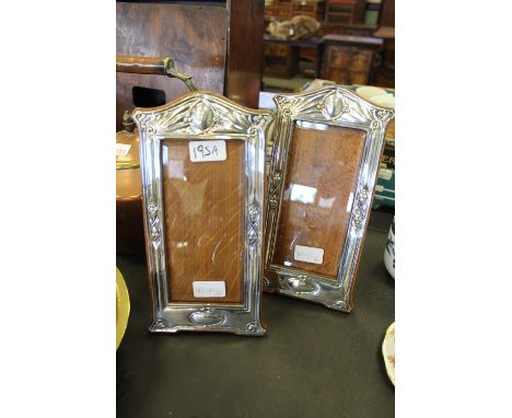 A pair of Edward VII silver photograph frames of Art Nouveau design, with slender floral embossed borders, Birmingham 1908/19