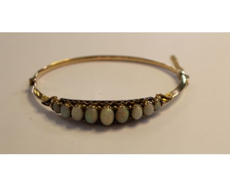 Late Victorian 9ct gold and graduated opal stiff bracelet