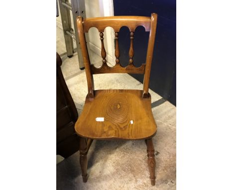 A set of four modern oak stick back kitchen chairs in the Victorian manner