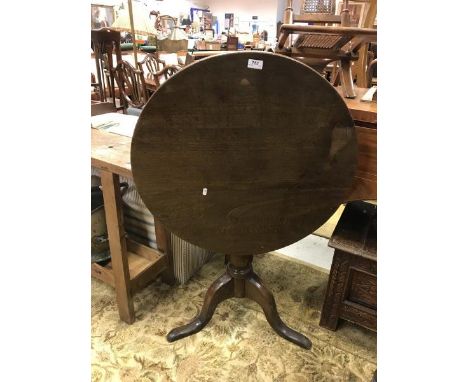 A 19th Century oak tea table, the circular snap top on a basic birdcage/block on a heavy turned pedestal to tripod base
