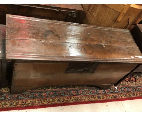 An 18th Century oak hutch with moulded and notch carved decoration raised on bracket feet 