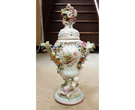 A 19th Century continental porcelain potpourri vase in the Meissen manner the main body of gourd form relief decorated with f