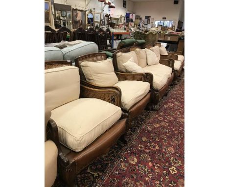 An early to mid 20th Century stained beech framed Bergere five piece suite comprising two seat sofa and four armchairs on she