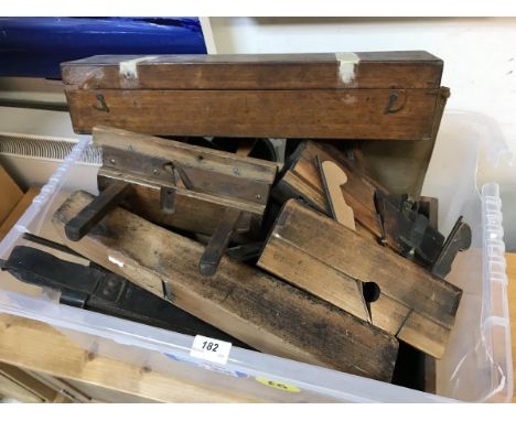 A collection of various vintage woodworking tools including a plough plane, another plane by W. Watkins of Bradford, moulding