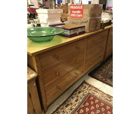 A pair of modern light oak chests of six drawers together with two oak bedside cabinets