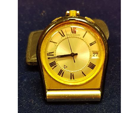 A mid 20th Century Jaeger Lecoultre folding travel clock with black lacquered mounts, the dial set with Roman numerals and da