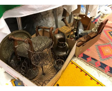 Two boxes containing various decorative items including small stool, embossed copper water jug, Indian brass tray, iron wirew
