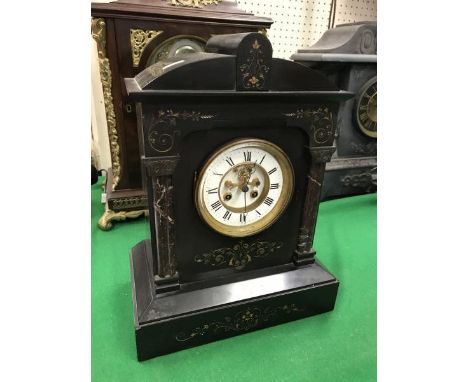 A late Victorian black marble cased mantel clock of architectural form, the eight day movement by Japy Freres with visible es