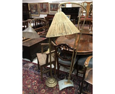 A retro brass standard lamp with painted metal base and wicker shade together with another brass standard lamp