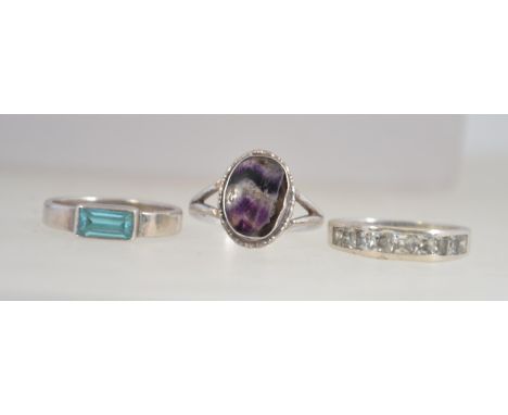 A collection of 3silver rings to include channel set, blue aquamarine type baguette ring and another. Total weight 9g. Sizes 