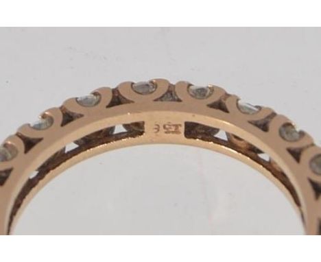 A tested 9ct gold full eternity ring with clear stones in a cup setting Marked 9ct. Weight 2.8g. Size M.