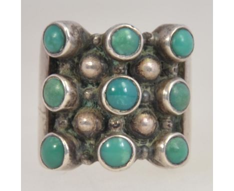 A retro 1970's brutalist silver 925 and turquoise set ladies dress ring inse with 9 round turquoise stones. Size K/l, weight 