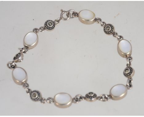 A silver 925 bracelet chain having illusion set stone spacers and mother of pearl roundels with a C clasp. Measures 14 inches