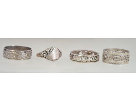 3 silver eternity rings, one with greek ket lattice work design, one with tree of life and the other with viking ships. Toget