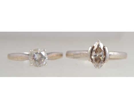 A silver single stone round cut cz solitaire ring together with another single stone ring. Sizes M.5 & N. Total weight 3.8g