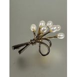 Property of the late Countess Haig: A gilt metal spray brooch set seven oval cultured pearls and a