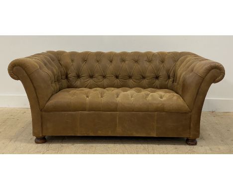 A John Lewis Chesterfield sofa, upholstered in deep buttoned suede leather, raised on turned walnut supports H68cm, L165cm, D