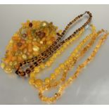 A vintage amber glass graduated bead necklace, (L x 27 cm), a natural amber nugget bead necklace, (L