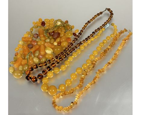 A vintage amber glass graduated bead necklace, (L x 27 cm), a natural amber nugget bead necklace, (L x 25 cm) and a collectio