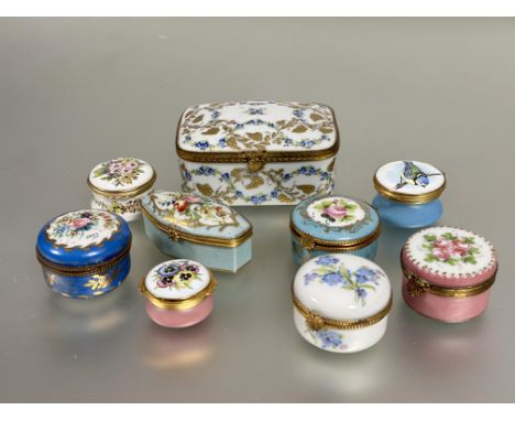 A collection of porcelain table boxes, including a large Limoges rectangular box with gilded leaves and grapes with jewelled 