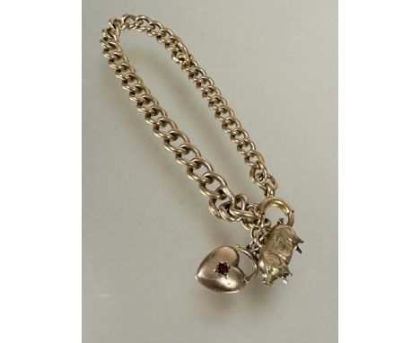 A 9ct gold kerb link chain bracelet with pig and heart charms and ring fastening, (D x 8 cm). 15.5g