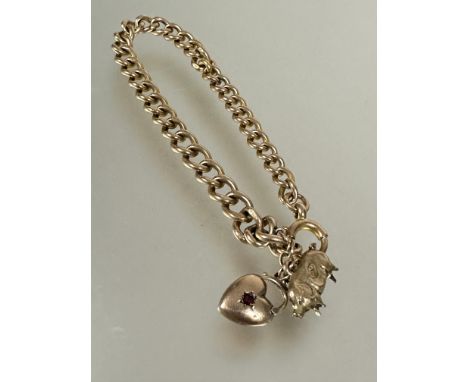 A 9ct gold kerb link chain bracelet with pig and heart charms and ring fastening, (D x 8 cm). 15.5g