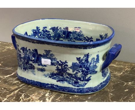 A Victorian style blue and white ceramic twin handled foot bath, decorated with romantic scenes and stamped Regency Ironstone