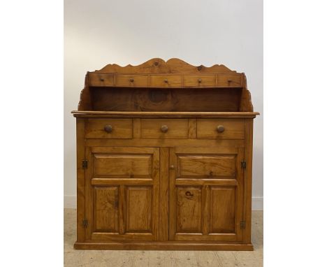 A Victorian style Scotch stained cedar wood dresser, the raised serpentine back fitted with five spice drawers, above three f