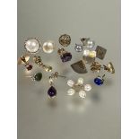 A collection of odd yellow and white metal earrings including a mabe pearl stud earring, cultured