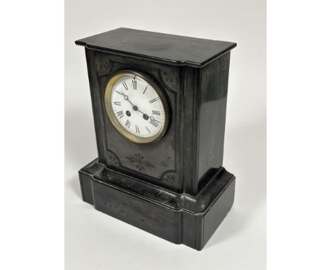 A Victorian black slate mantle clock with moulded top, engraved panel to front and white enamel dial Roman numerals and twin 